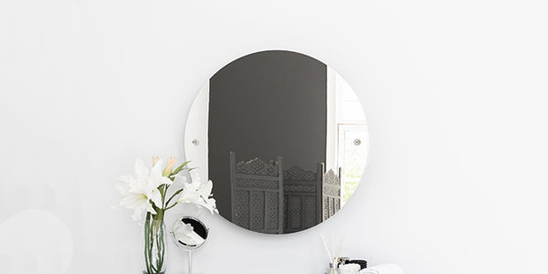 Brass rail mounted frameless wall mirror